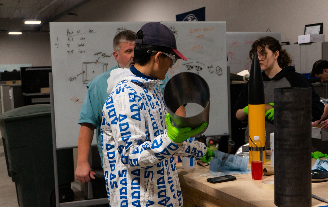 Team members working diligently on developing a cutting-edge frame design.